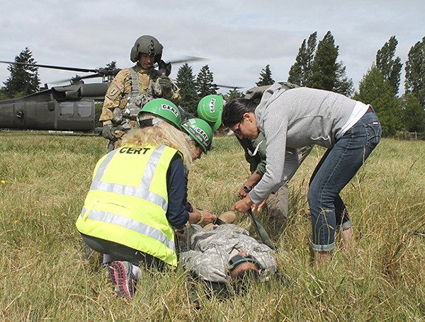 The National Guard trains Vashon volunteers in helicopter loading procedures at Sunrise Ridge.