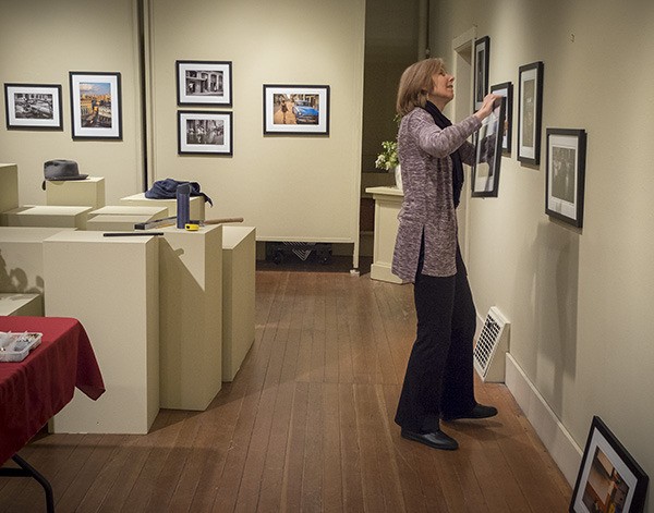 Janice Mallman hangs the final show at the Blue Heron.