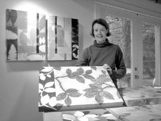 Islander Mary Margaret Briggs in her studio shows one of her textile panels with leaf images. Her work will be on the Art Studio Tour at location #9 in the tour brochure.