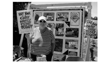 Quilter Catholine Tribble sells raffle tickets at a recent Saturday Farmers Market.