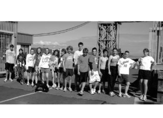 Members of the cross-country team take a break at the north-end ferry dock after their Dock 2 Dock run Saturday