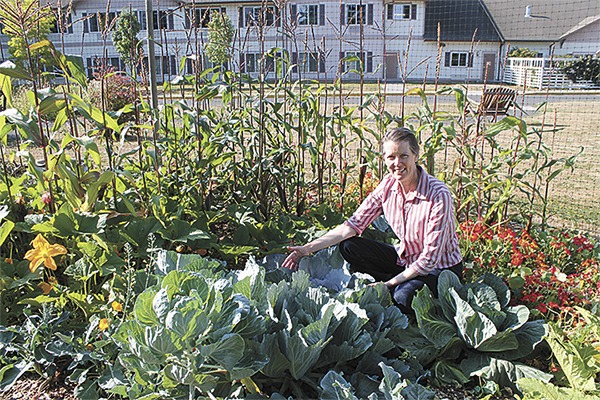 Julia Lakey shows off her abundant harvest in the dry garden at Vashon Community Care.