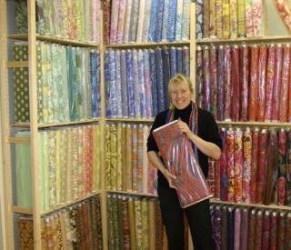 Anja Shive Moritz prepares her new store downtown and is planning for a Feb. 7 and 8 grand opening. All the fabric is encased in plastic to keep it clean during the hustle and bustle of moving.