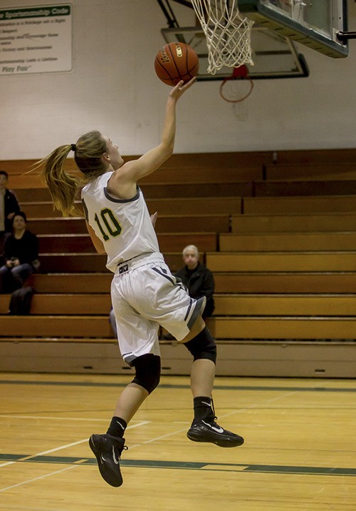 Senior Annika Hille goes up for two points during a home game.