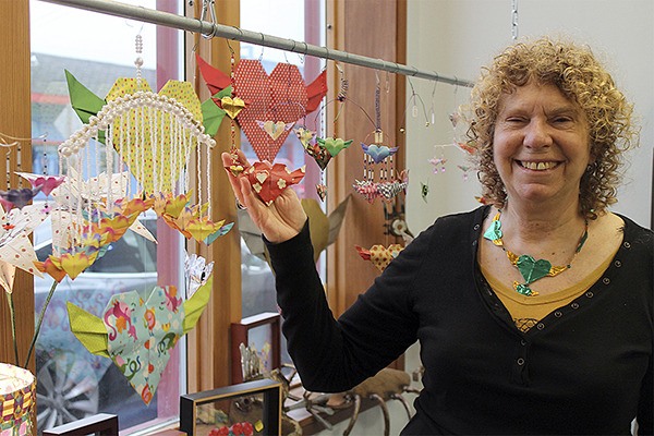 Alice Larson shows off handmade hearts in her gallery