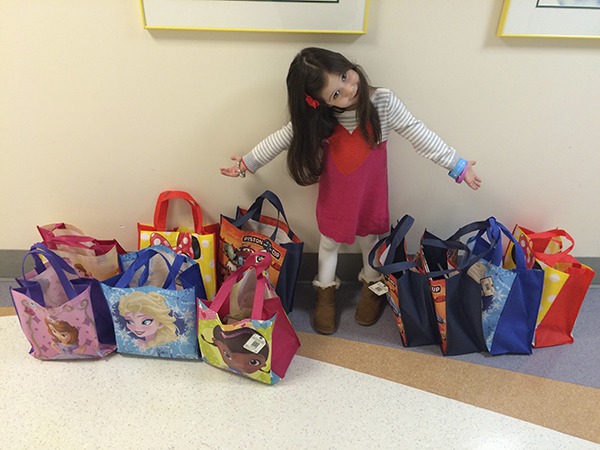 Violet Spataro shows the “Blessing Bundles” she will share with other young cancer patients and survivors.