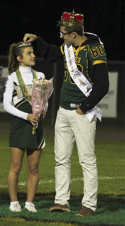 VHS Senior Chester Pruett adjusts fellow senior Delaney Anderson's crown during the presentation of Homecoming royalty at last Friday's football game.