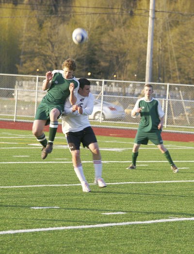 Vashon defender Jesse Turner beats Orting’s striker to a header midway in the second half of Tuesday’s 1-1 tie game at Orting.