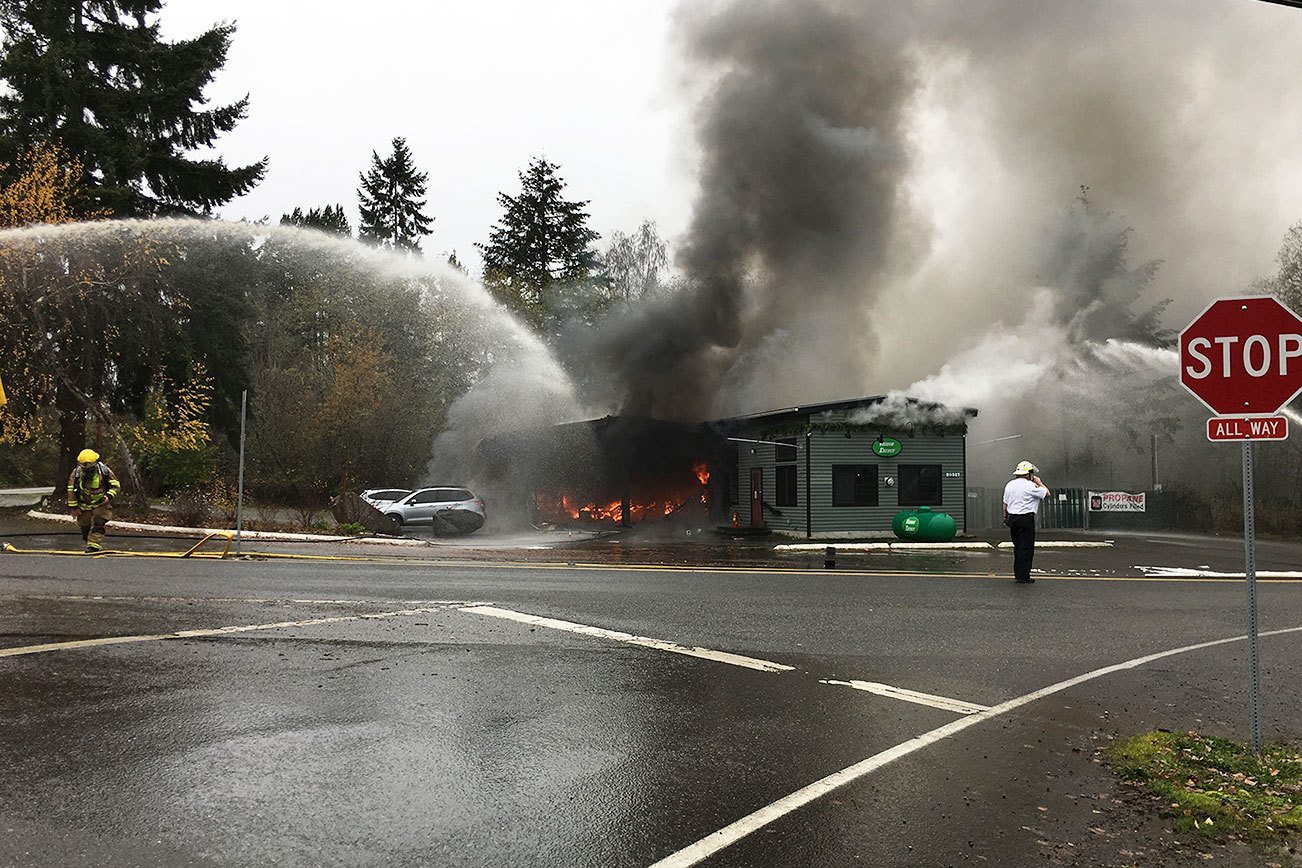 Courtesy Photo                                Fire hoses spray water onto the flames as Vashon Energy burns on Friday afternoon.