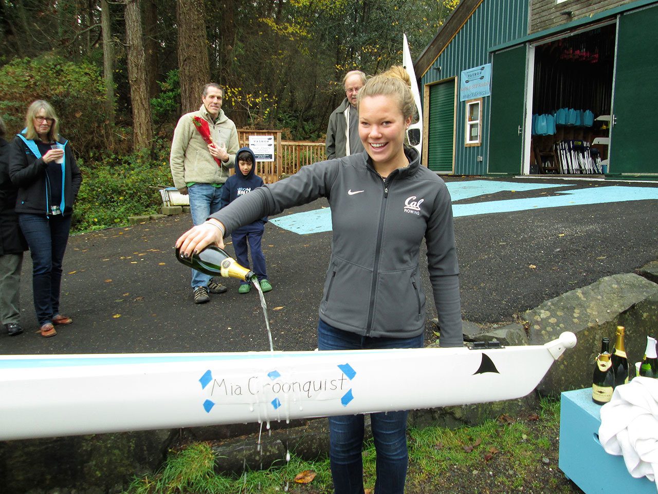 Colby Atwood Photo: Mia Croonquist christens the new eight-person rowing shell named after her.