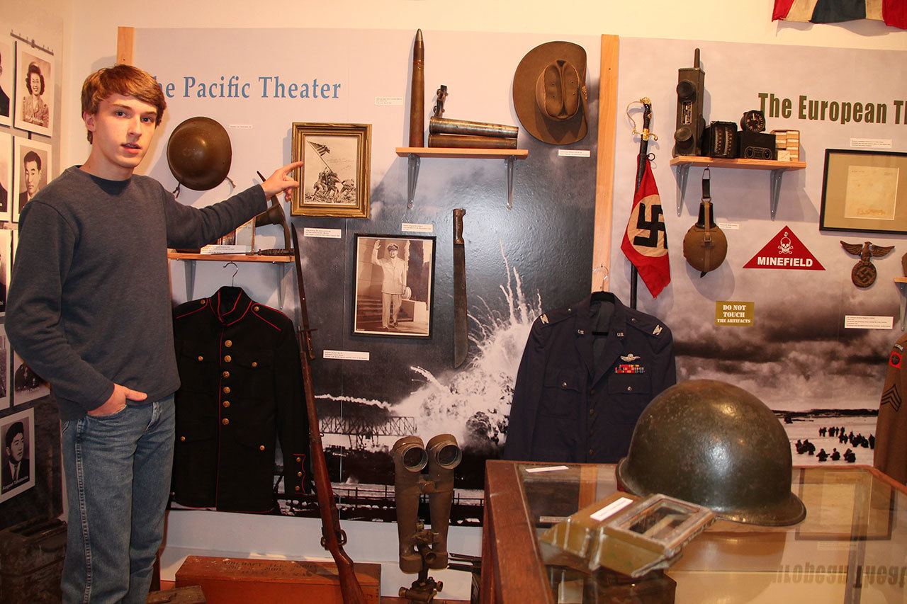 Kjell Urban stands with his collection of World War II memorabilia at the Vashon Maury Island Heritage Museum. His collection is currently on display as the museum’s newest exhibit, “Vashon and World War II: A Personal Collection.” (Juli Goetz Morser/Staff Photo)