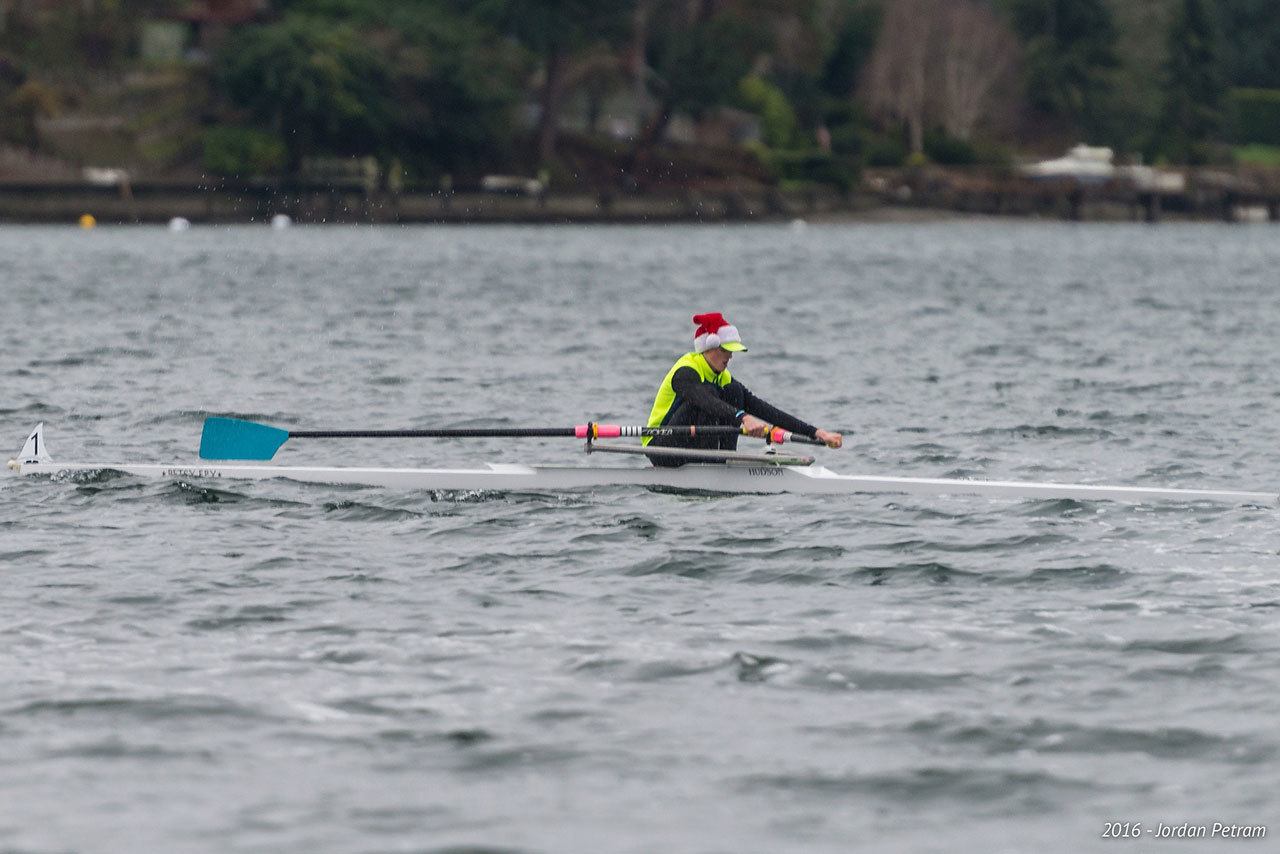 Decked out in a Santa hat, Vashon Island Rowing Club junior Aidan Teachout takes to the water in a single during the VIRC Solstice Scrimmage on Sunday. (Jordan Petram Photo)