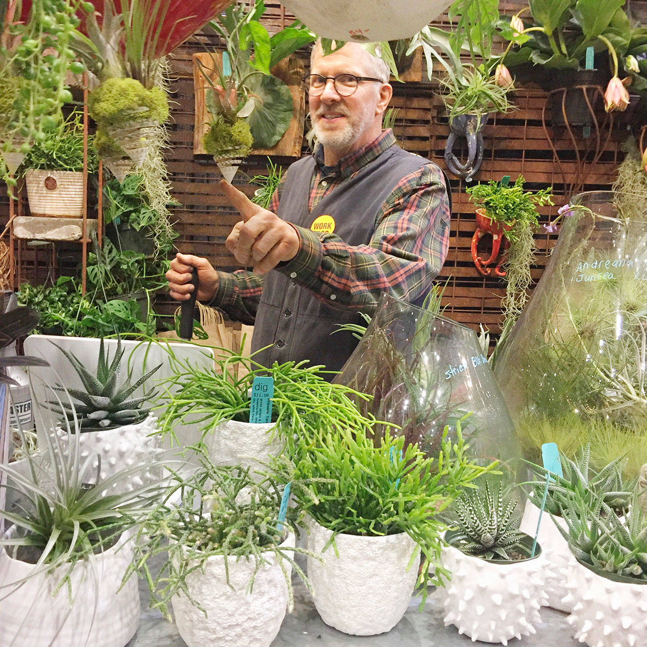 DIG Nursery co-owner Ross Johnson stands inside the island business’ pop-up shop at the Northwest Flower & Garden Show. (Courtesy Photo)