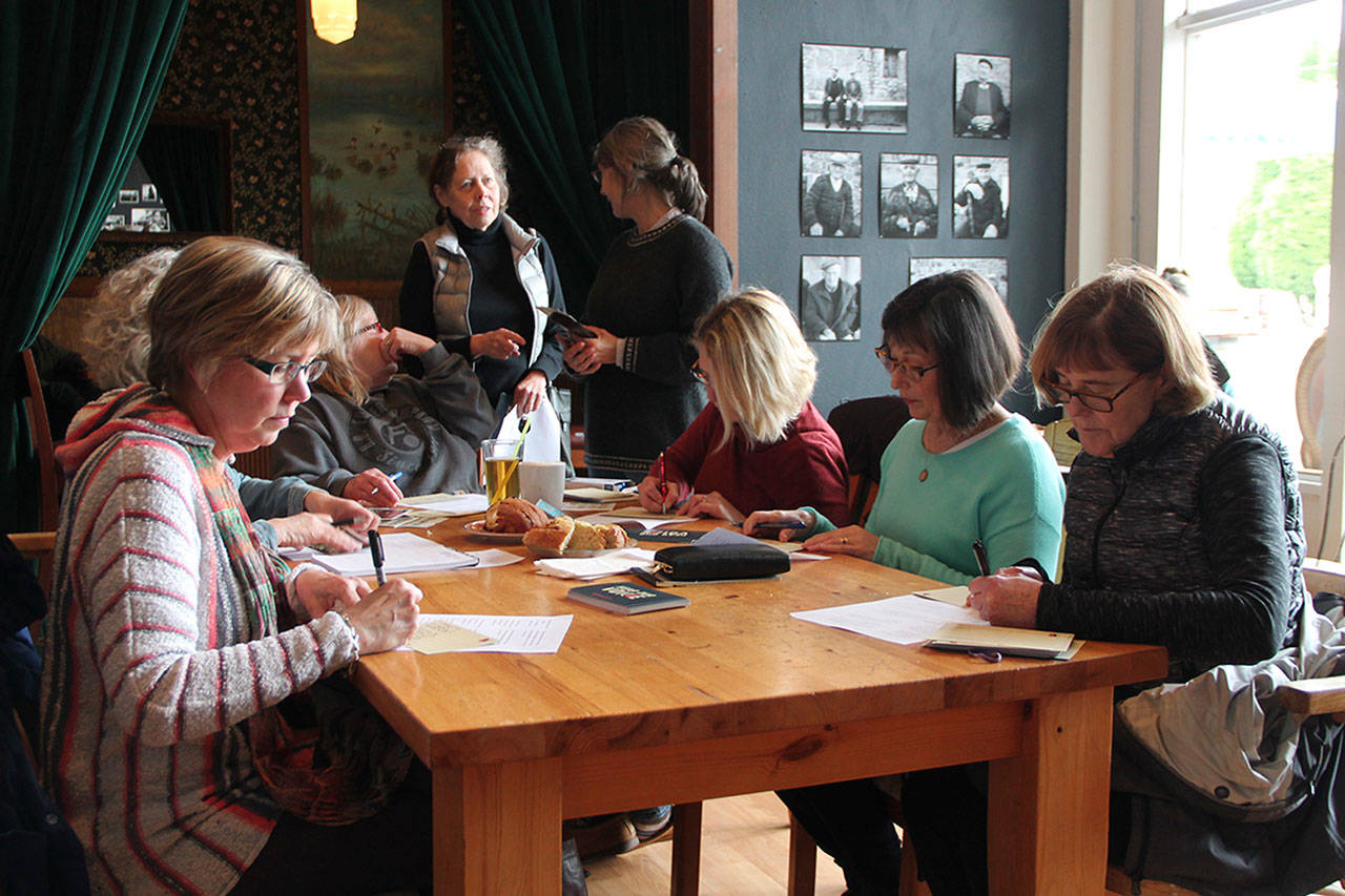 Vashon Resistance participants gather each Thursday at Snapdragon to write letters to government officials.(Susan Riemer/Staff Photo)