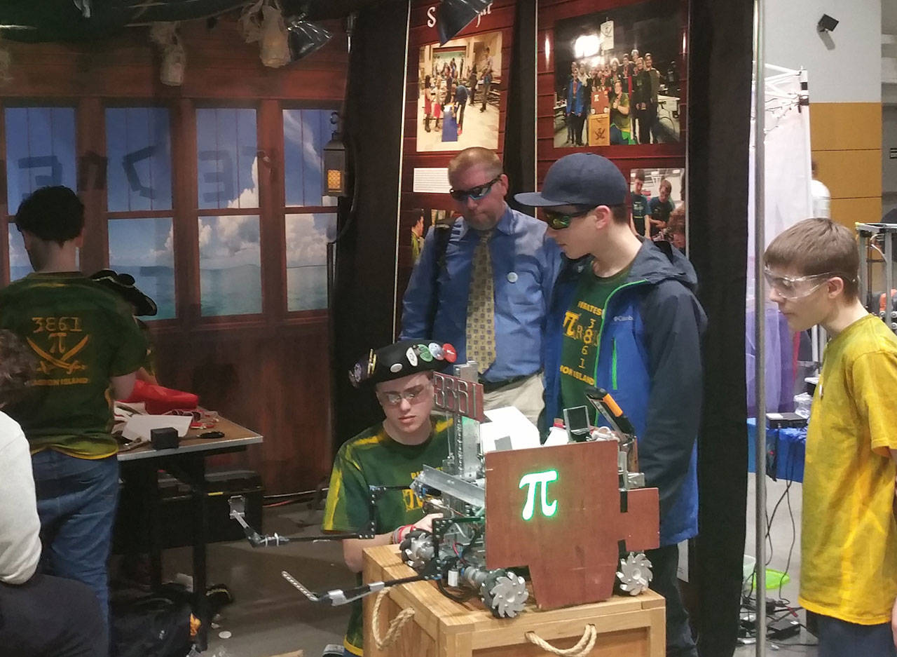 Vashon Pi-R8s team members work on their robot at the super-regional competition in Tacoma last weekend. Vashon teams have made it to the multi-state competition twice in its 10-year history. (Bruce Johns Photo)