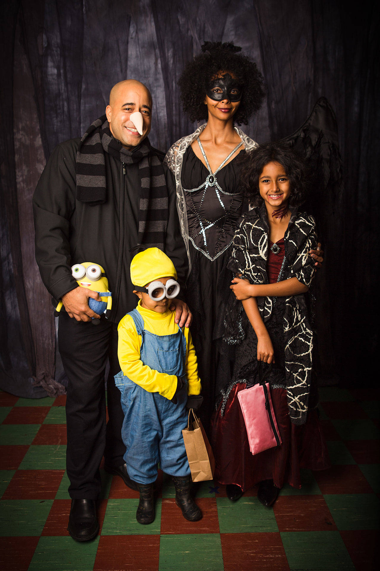 Brennan and Coco Banks with their children William and Cassandra at Cafe Luna last Halloween. The Halloween portraits are just part of what makes the island the community-minded place the family hoped for. (Marla Smith Photo)