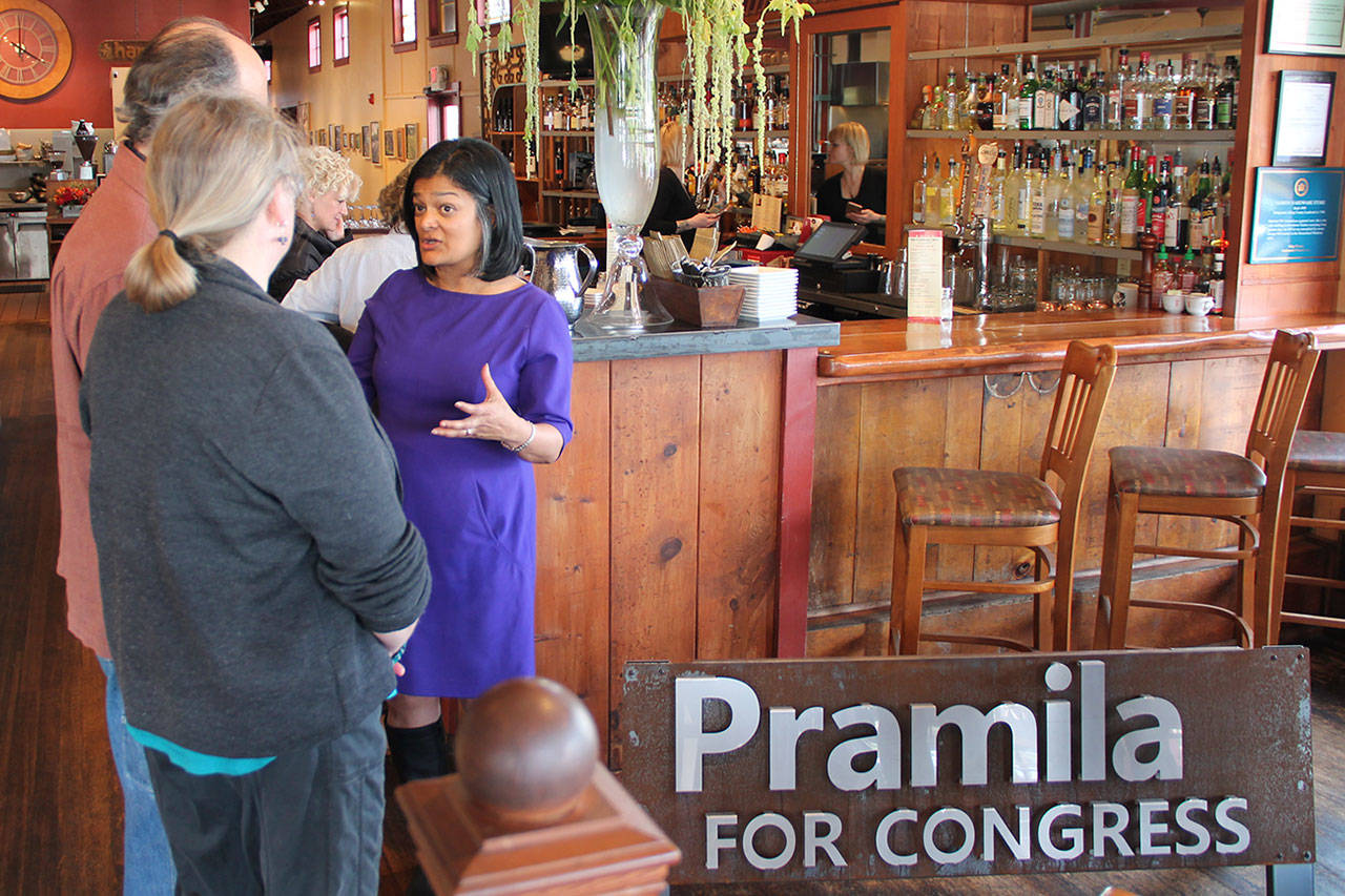 U.S. Representative Pramila Jayapal talks to islanders Bob Powell and Margot Boyer at The Hardware Store Restaurant ahead of her town hall Thursday night. (Anneli Fogt/Staff Photo)