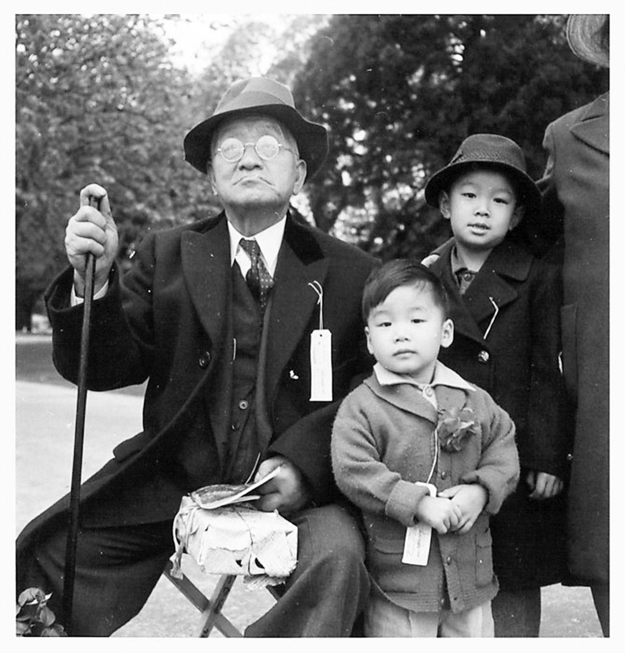 A Japanese American family waits to be taken to a war relocation center after the signing of Executive Order 9066. (Courtesy Photo)
