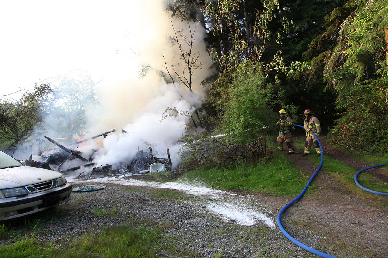 Firefighters work to extinguish the blaze on Westside Highway. (David Weller Photo)