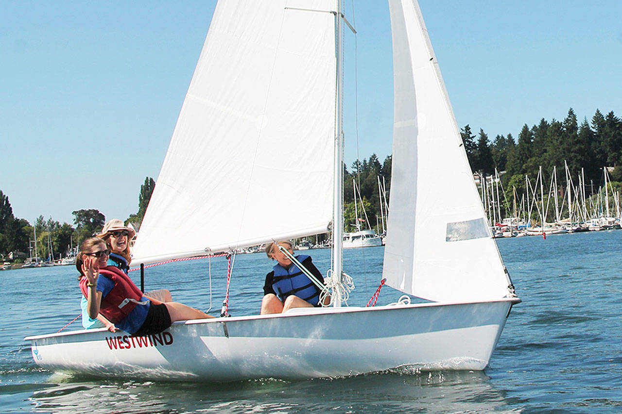Islanders Pam Ingalls (left, back) and Melinda Powers (right) learn to sail through the Bruce Haulman Junior Sailing Program with their instructor Audrey Benner (left, front). (Susan Riemer/Staff Photo)