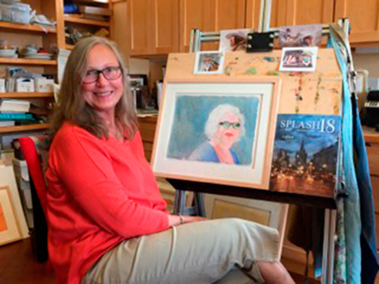 Donna Botten sits before her watercolor,“Spectator,” published this year in “Splash 18.” (Juli Goetz Morser Photo)