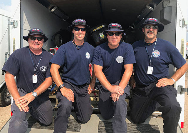 Central Pierce Fire Rescue firefighters and members of VHS’ class of 1997 Josh Farris (second from left) and Andy Moe (third from left) with other members of the Central Pierce Fire Rescue department in Texas. (Courtesy Photo)