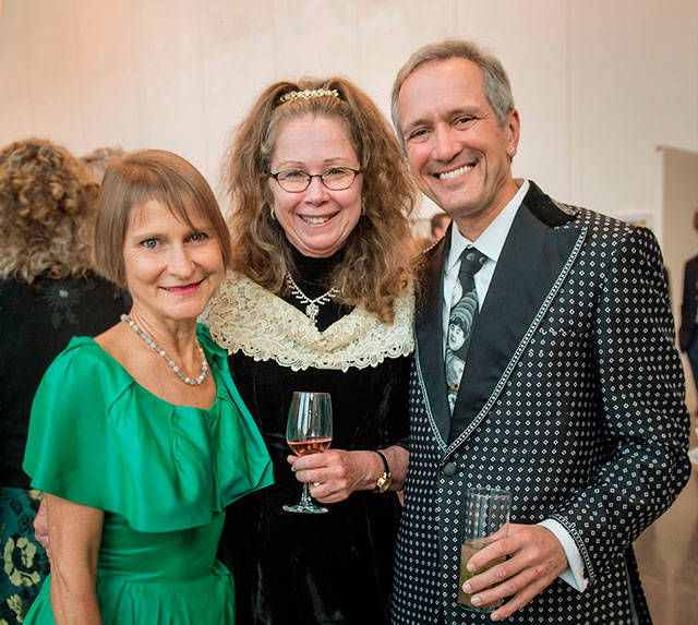 Left to right: Open Space for Arts & Community’s Janet McAlpin, Vashon Center for the Arts Executive Director Susan Warner and Open Space’s David Godsey enjoy a moment together at Vashon Center for the Arts’ recent auction. (Courtesy Photo)