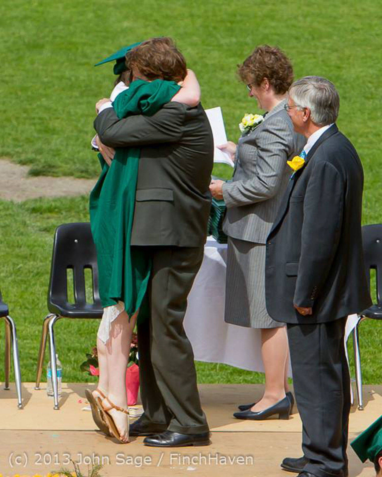 Bob Hennessey hugs his daughter Emma, after giving her her high school diploma at her graduation from Vashon High School in 2013. (John Sage/FinchHaven Photo)