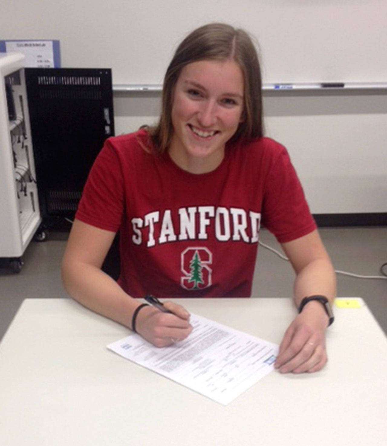 Riley Lynch signs her letter of intent to join Stanford University’s rowing team. (Sarah Low/Staff Photo)
