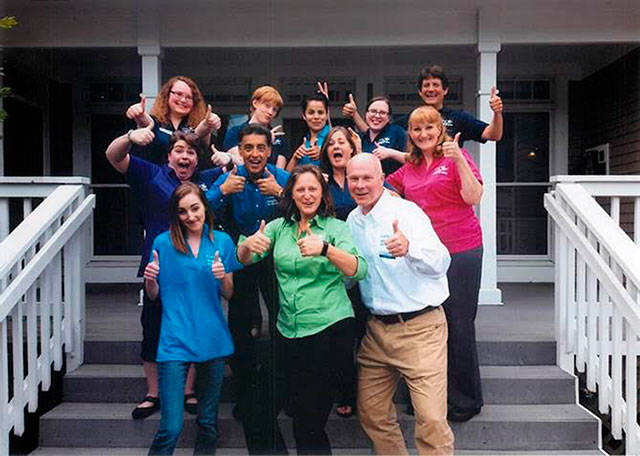 Owners Rob and Marilyn Oswald, right and center front, share a lighthearted moment with their staff. (Courtesy Photo)