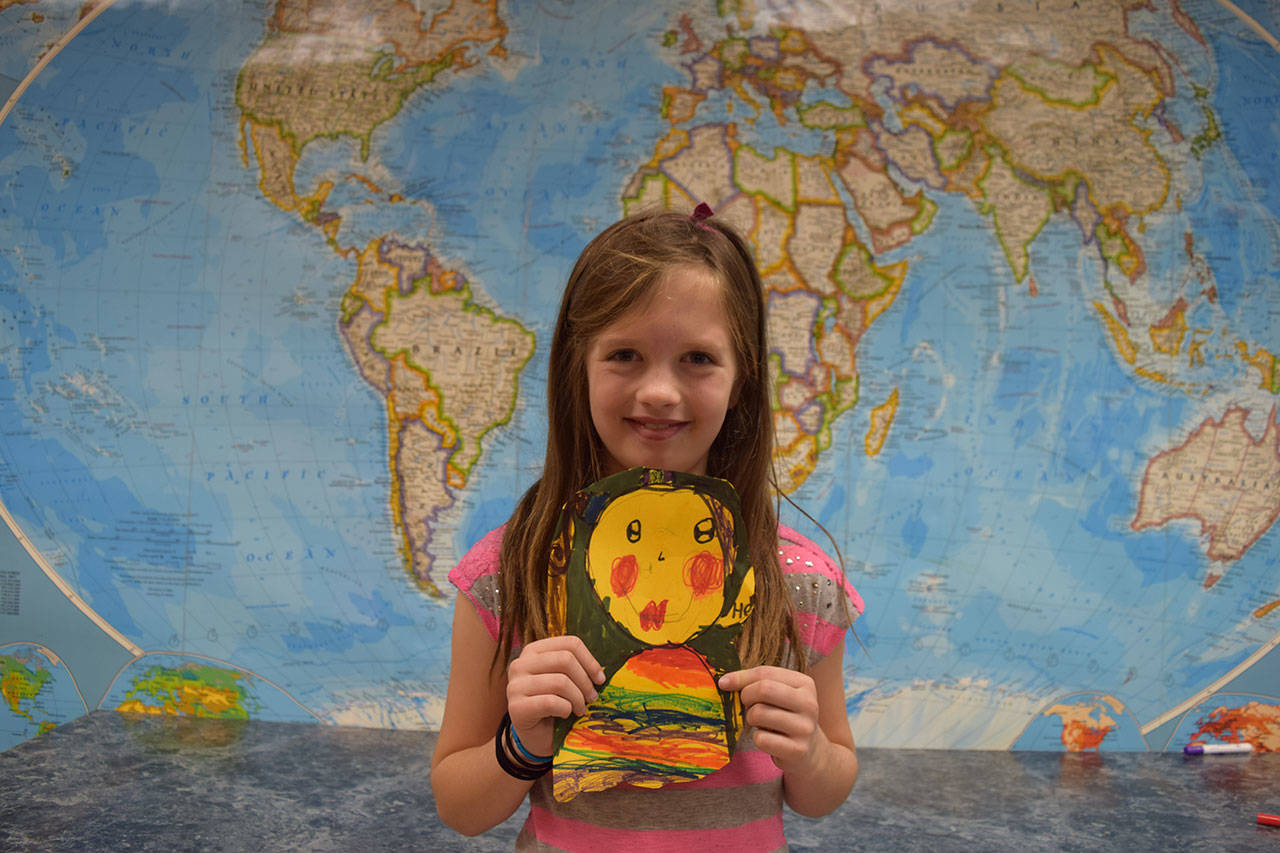 Chautauqua student Maude Jackson with the self portrait art she will send to a Mexican children’s shelter with Staff member Sally Adam later this week. (Courtesy photo)