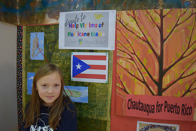 Neko Rogneby with a display for Chautauqua’s Puerto Rico fundraiser. (Courtesy Photo)