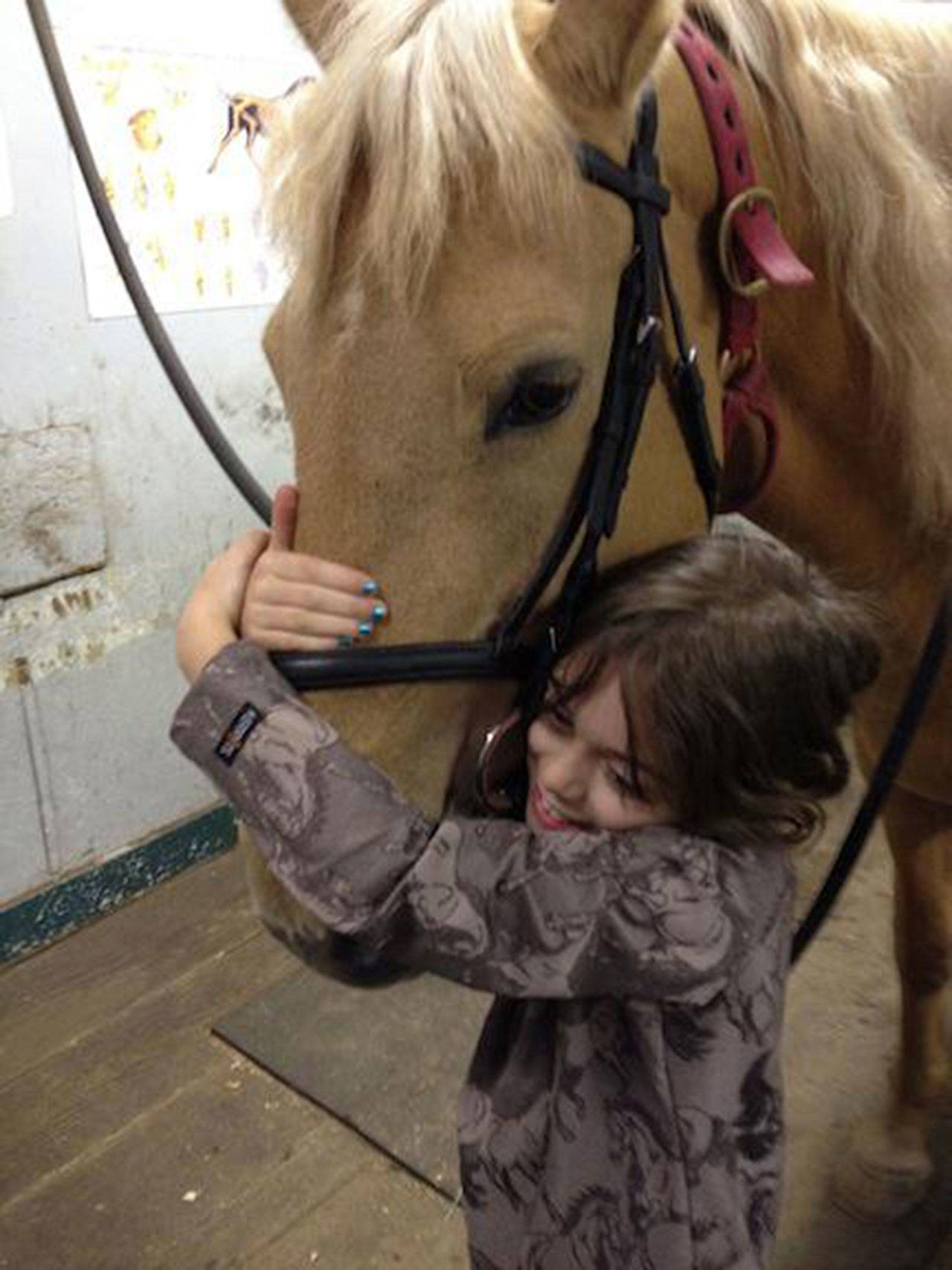 The horse that started it all, Tasha, with a young friend. (Courtesy Photo)