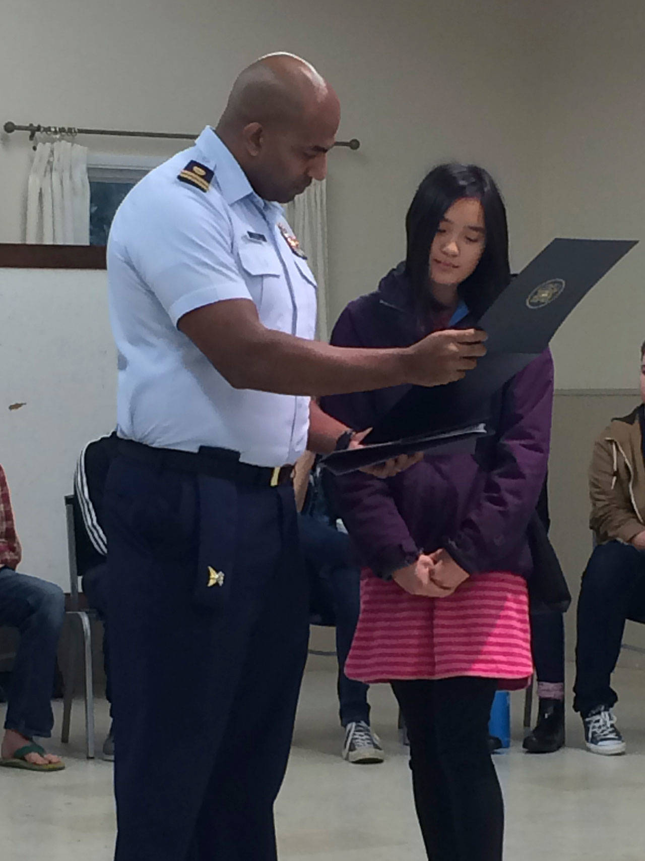 Flora Briggs receives her commendation from U.S. Coast Guard (Portland) Lt. Michael D. Tappan. (Courtesy Photo)