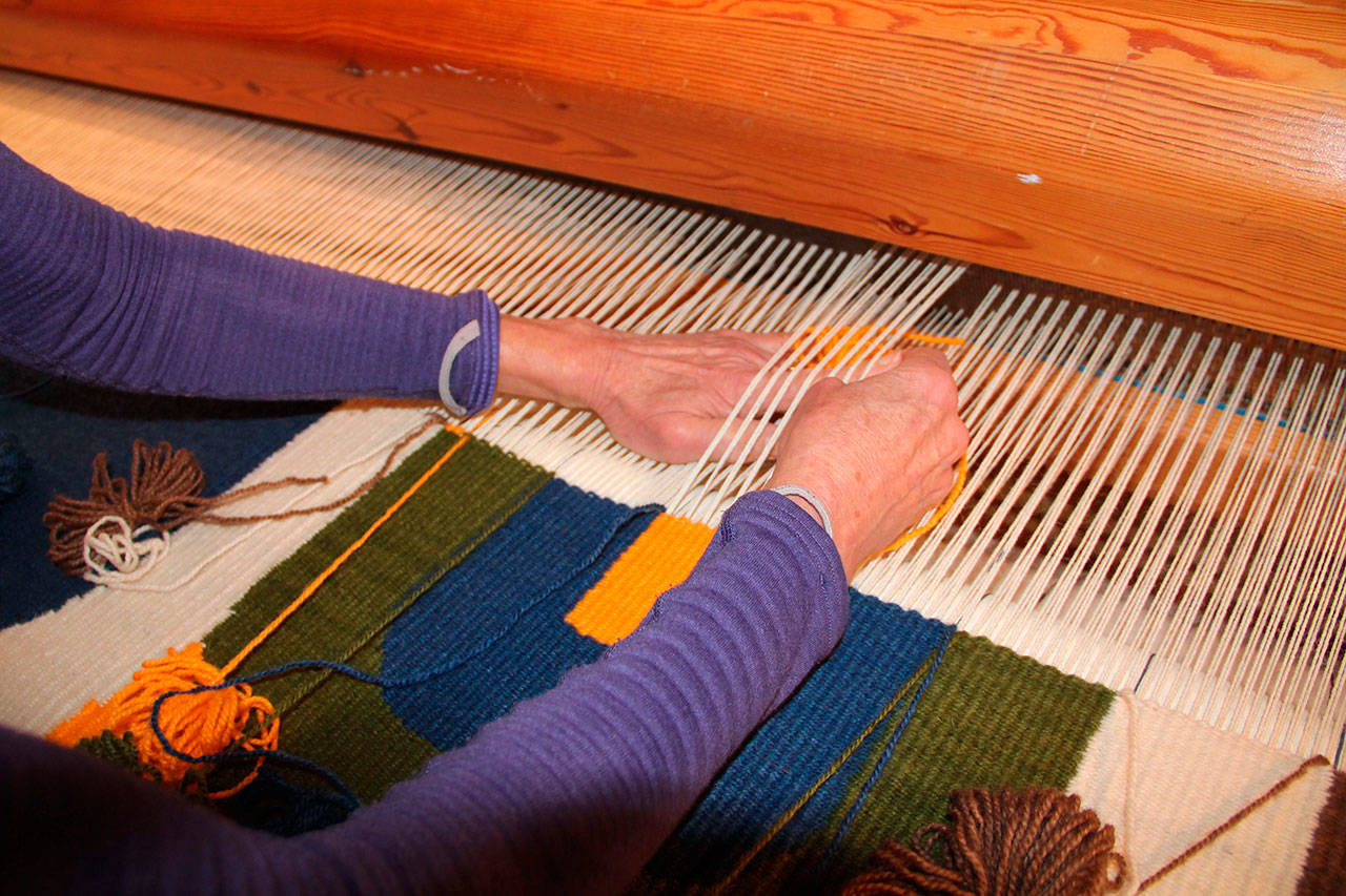 Suzanne Hubbard hand-weaves her tree tapestry (Juli Goetz Morser Photo)