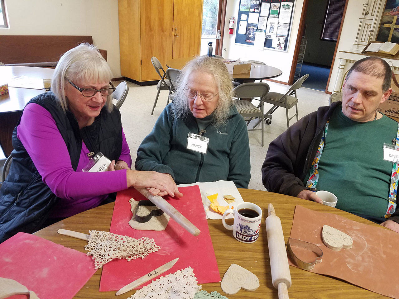 A volunteer leads a Valentine’s cookie-making session at Vashon Elder Care. (Courtesy Photo)