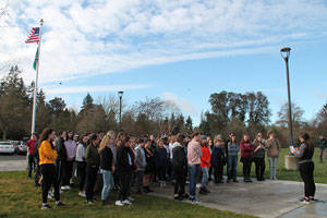 Katy Sassara addresses the students participating the in the walkout at the high school on Wednesday. (Paul Rowley/Staff Photo)