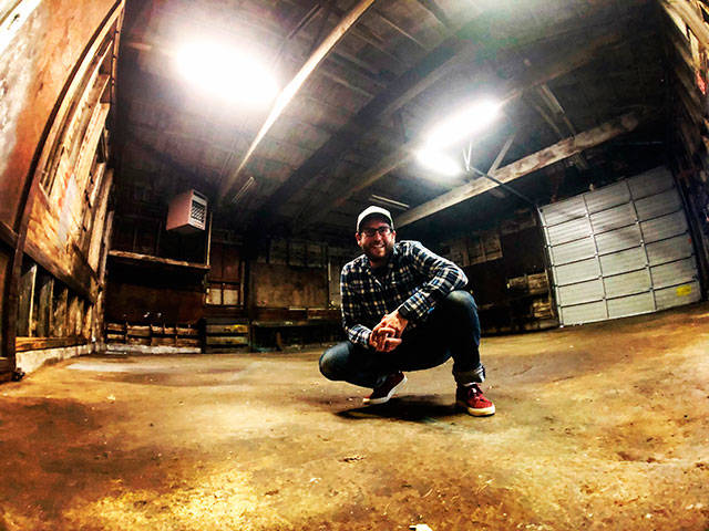 Matthew Lawrence, of Camp Colvos Brewing, poses inside the old Kimmco, Inc. building (Courtesy Photo).