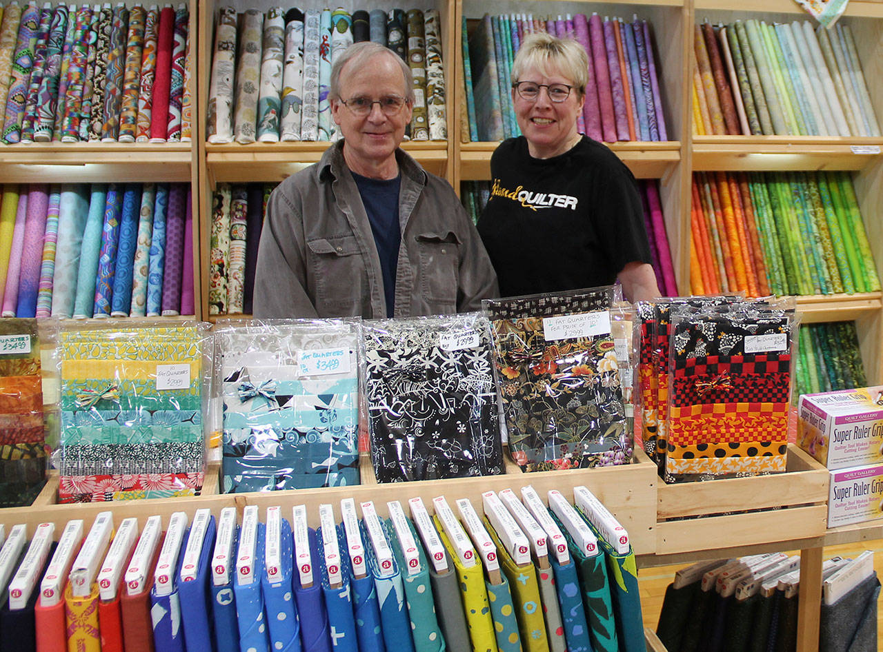 Island Quilter’s Paul Robinson and Anja Moritz participated in the recent Vashon Quilt Guild’s show in the Vashon High School gym. Soon the shop will be open again in downtown Vashon after closing three years ago. (Susan Riemer/Staff Photo)