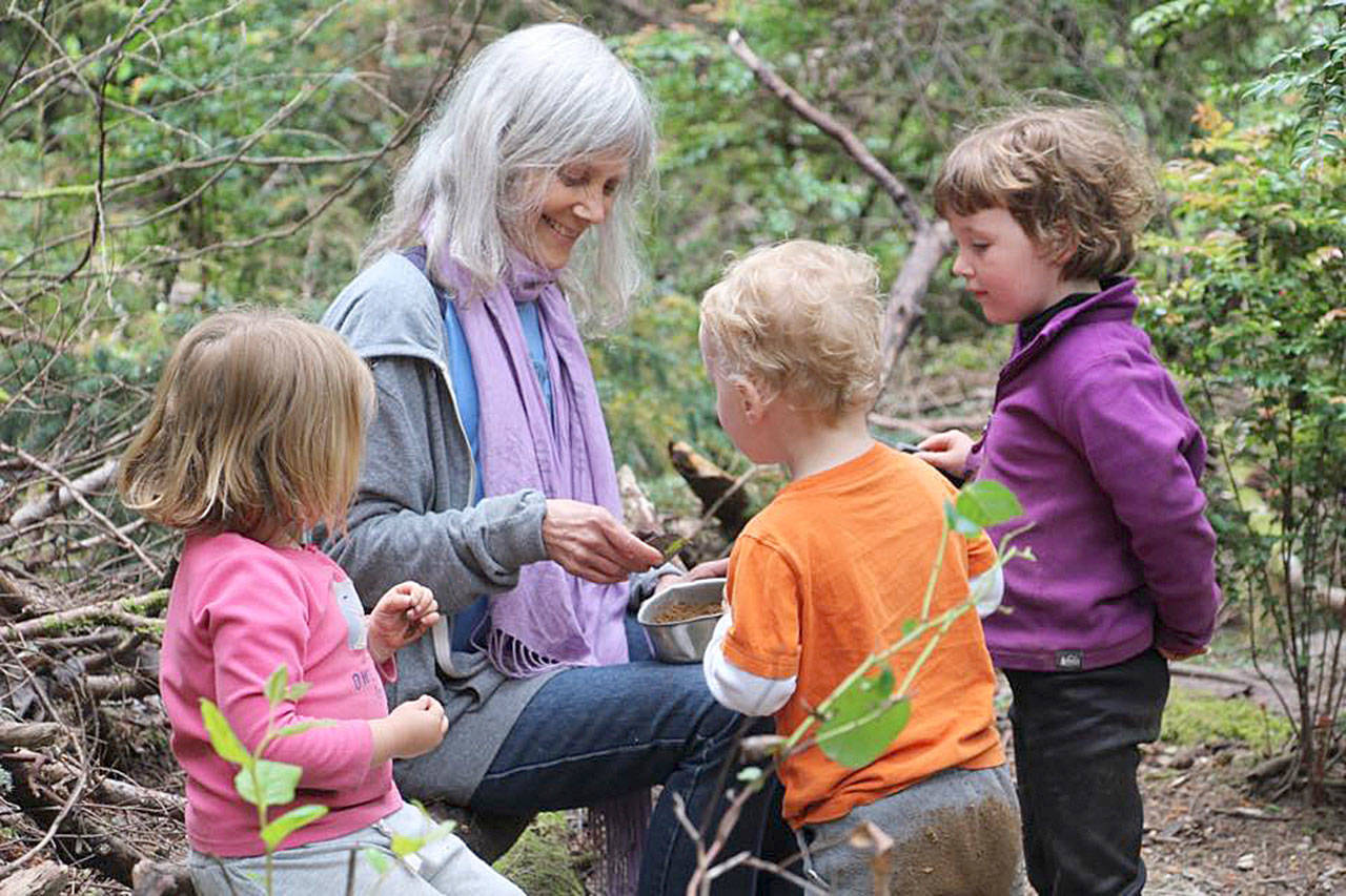 Erin Kenny shares a moment with children at Cedarsong (Niki Buchan Photo).