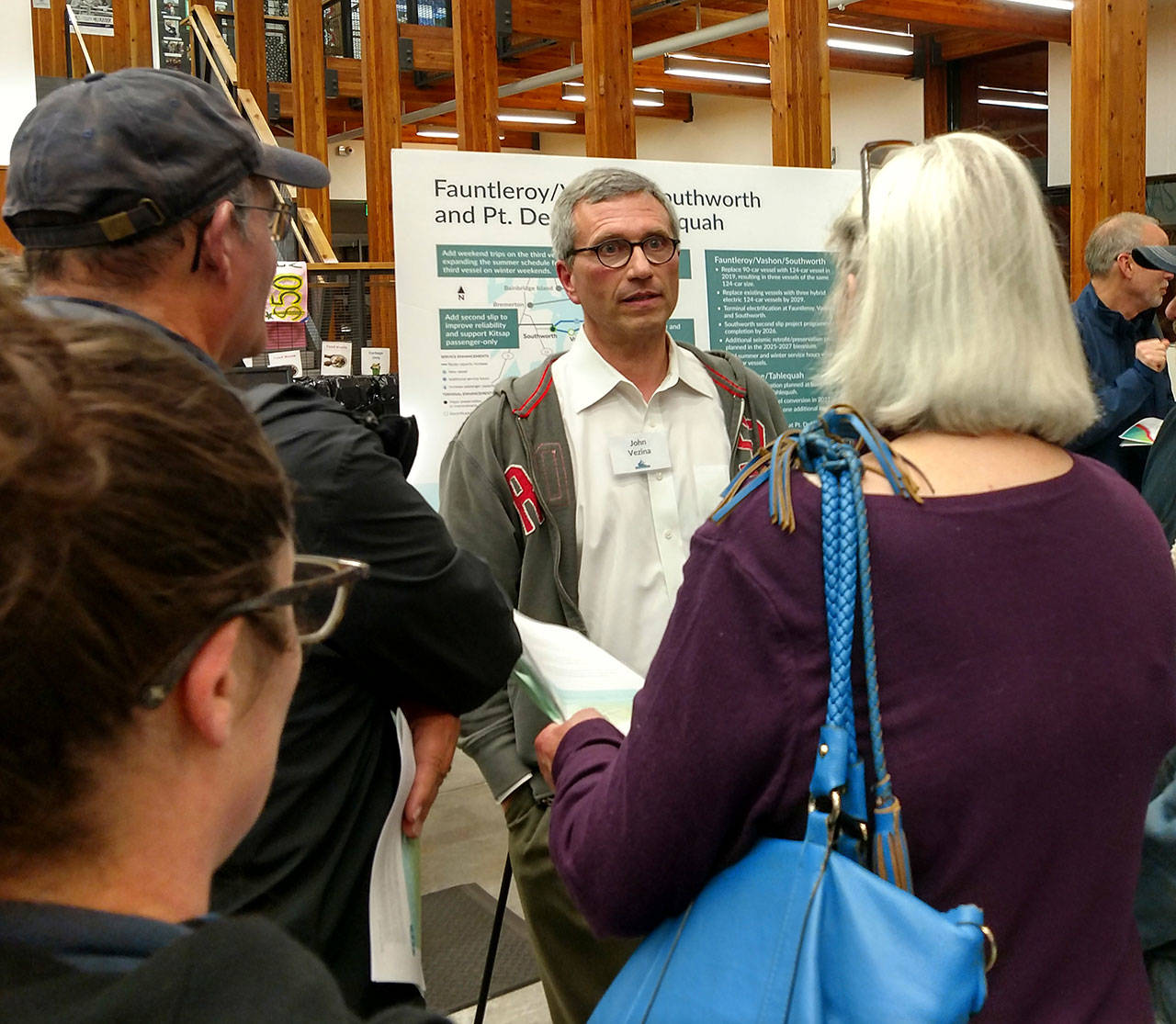Washington State Ferries Government Relations Director John Vezina talks with islanders at the ferry schedule meeting last week. (Susan Riemer/Staff Photo)