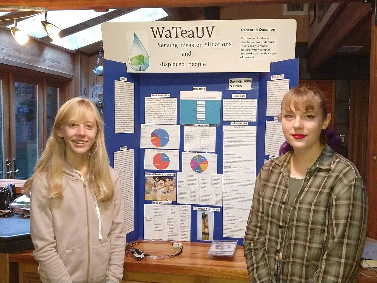Iris Bordman and Alyssa Hawkins with their humanitarian, enviro-science project at the Washington State Science & Engineering Fair in Bremerton last spring. (Courtesy Photo)