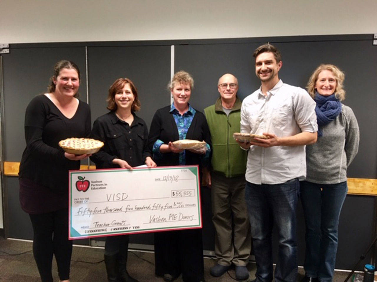 Teachers and PIE board members make a presentation to the school board at the Dec. 13 meeting. Left to right, they are Amy Holmes, Jenna Riggs, Esther Morrison, John “Oz” Osborne, Andy Callender and Carrie Van Buren. The lucky teachers who received grants also received a pie. (Courtesy Photo)