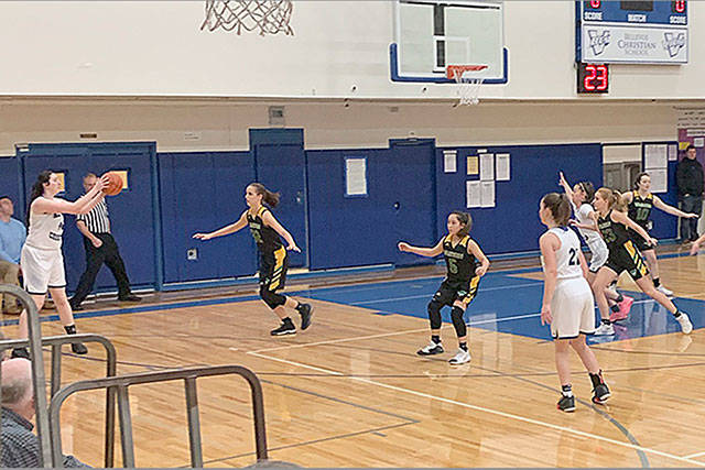 The girls’ basketball team, playing in the Trout Lake tournament, above, is in the midst of its most winning season in years. (Chris Kobelin Photo)