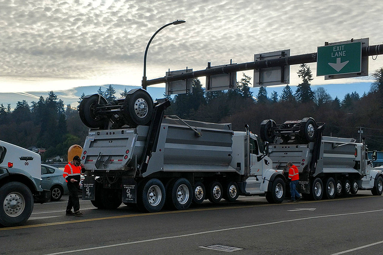 Trucks in line to take millings off island last Thursday. (Susan Riemer/Staff Photo)