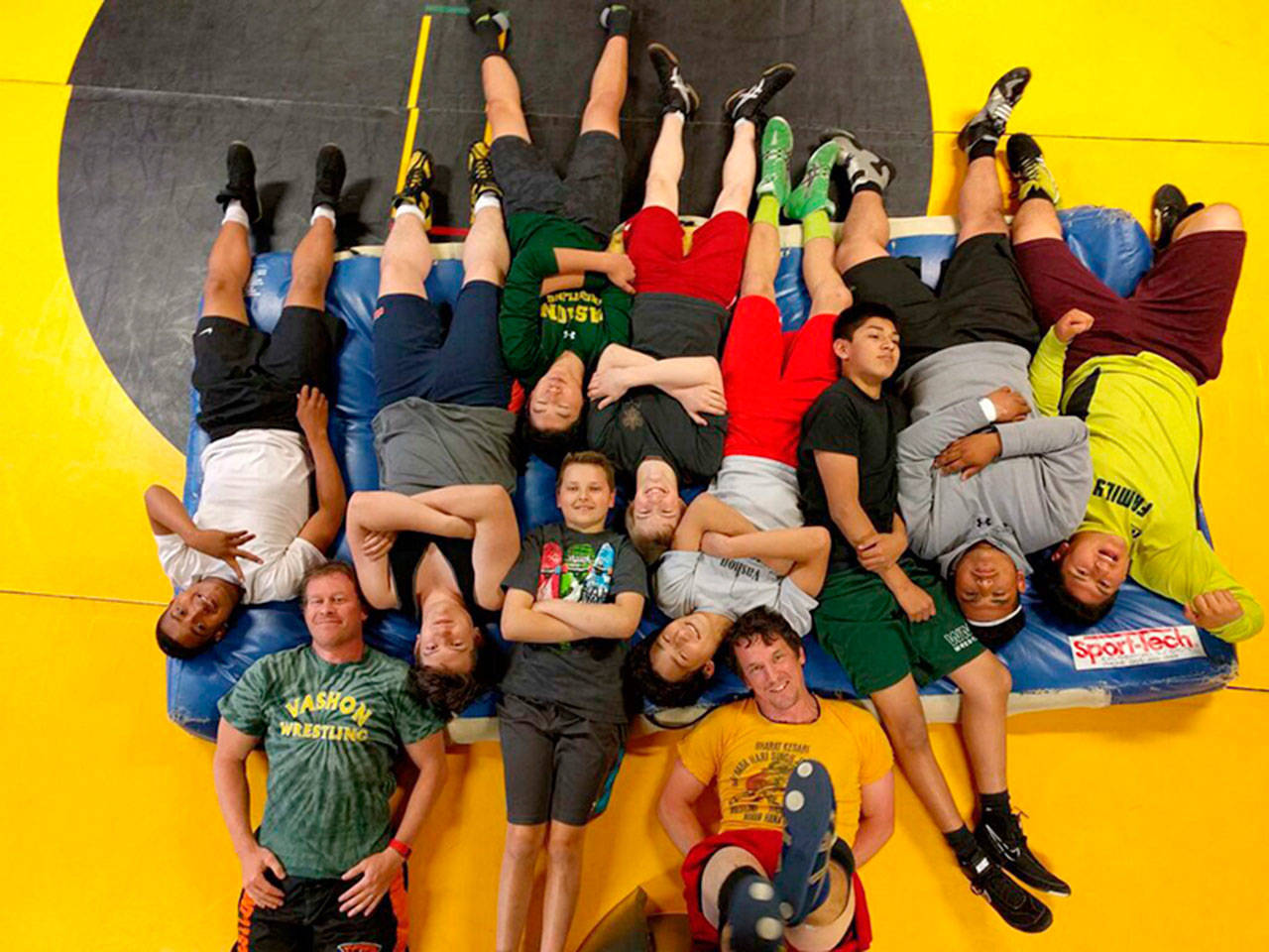 Anders and Per Lars Blomgren, left and right at the bottom of the photo, having some fun with wrestlers during a summer training session in 2017 (Courtesy Photo).