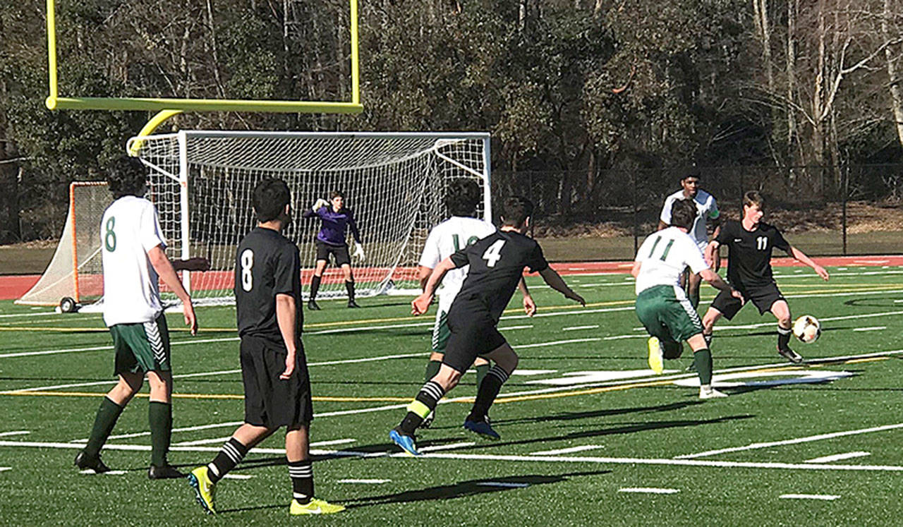 Jakob Heuschert (#11) controls the ball with Tommy Delargy (#4) on approach in last Saturday’s game against Overlake (Rose Eades Photo)