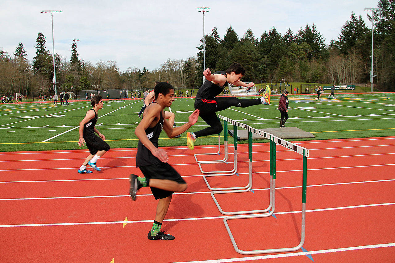 Boys compete in the 100-meter hurdles at the first home meet at the new track and field last week (Susan Riemer/Staff Photo).