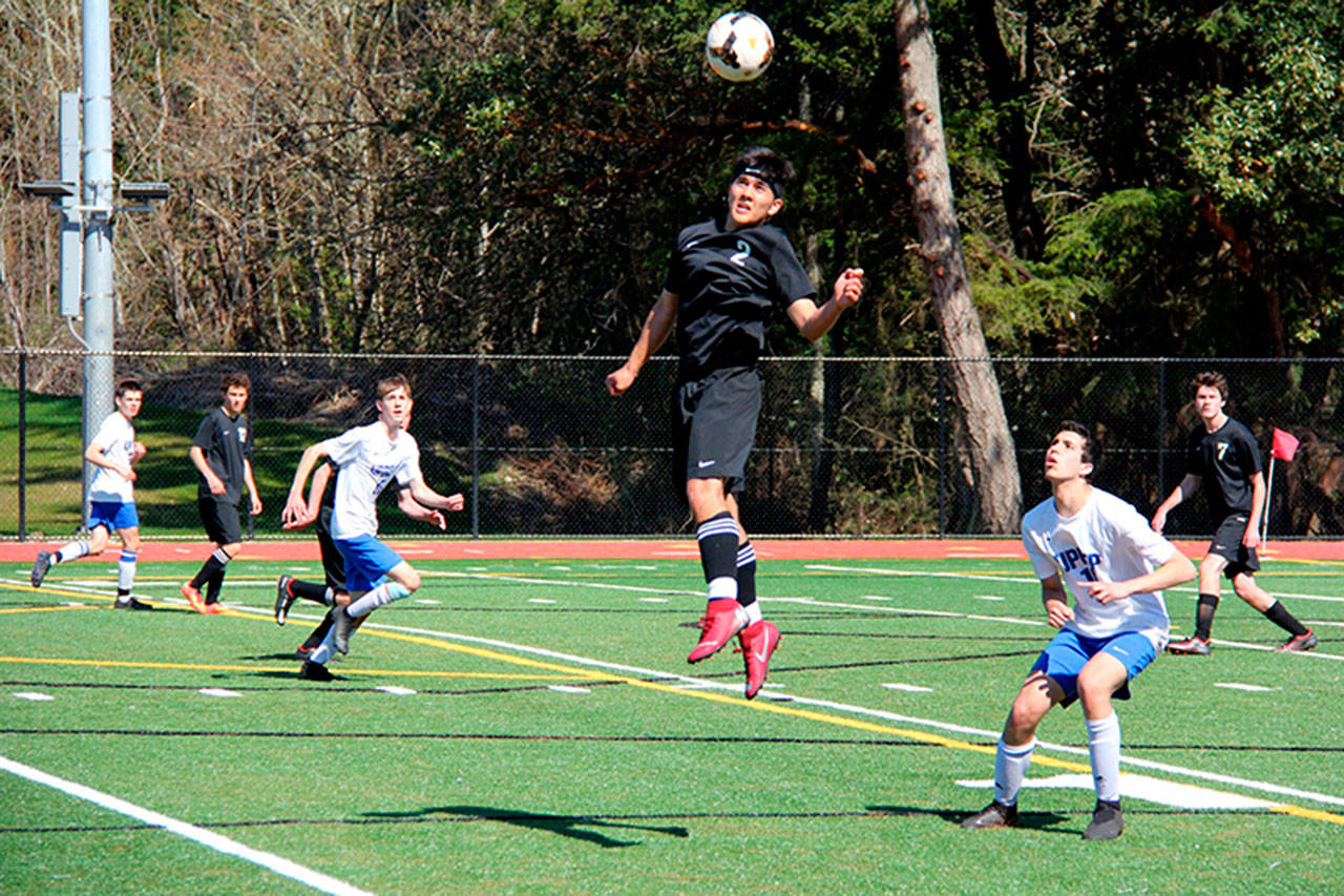 Pirates senior Isaac Ajeto heading the ball against University Prep on Saturday (Rose Eades Photo).