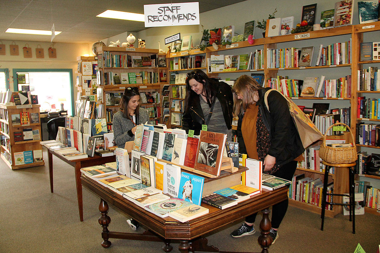 Vashon Bookshop, in the town center of Vashon, has been in business for 18 years. Along with other independent bookstores nationwide, it will celebrate Independent Bookstore Day on Saturday, April 27. Above, customers browse in the shop last weekend (Susan Riemer/Staff Photo).